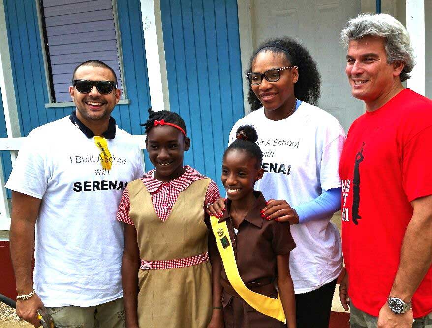 Sean Paul, Serena Williams and Karl Hale stand with students from the Salt Lake School Build in Jamaica.